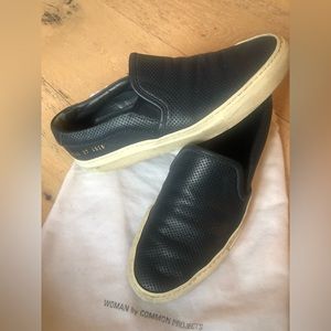 Woman by Common Projects slip-on sneaker.  Perforated style in navy blue.